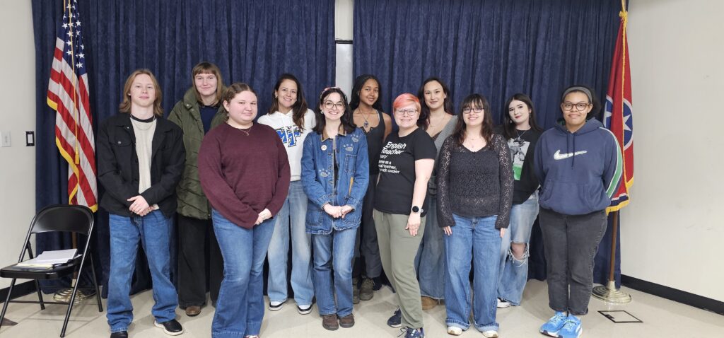 Spring 2026 Collage staff, group photo of students standing on a stage